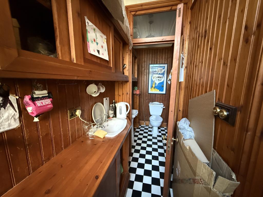 Lot: 10 - GROUND FLOOR COMMERCIAL INVESTMENT - WC and kitchen area with wood panelling